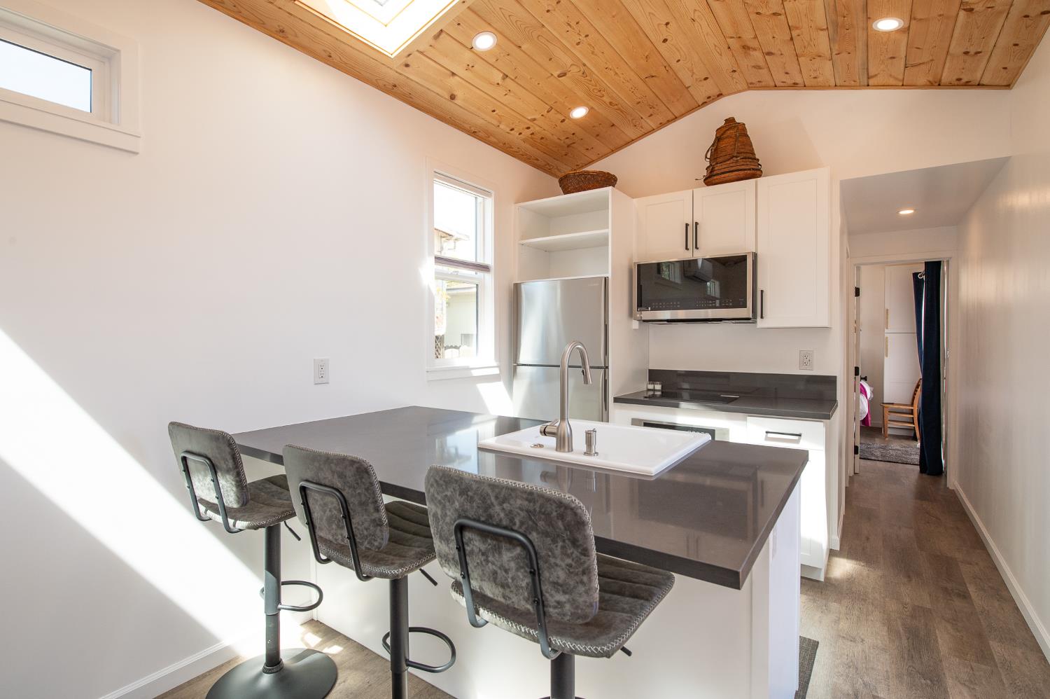 207 North Montgomery Street Ojai, CA 93023 - Photo 6 of 11 a kitchen with a table chairs microwave and cabinets