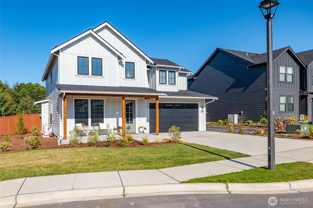 a front view of a house with porch and garden