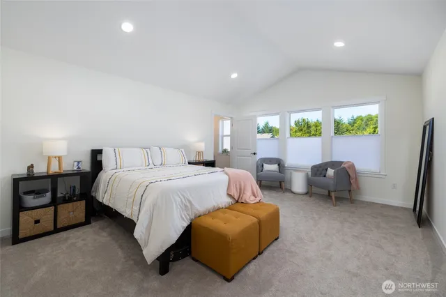 a spacious bedroom with a bed and a couch