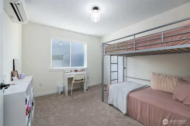 a spacious bedroom with a bed and a window