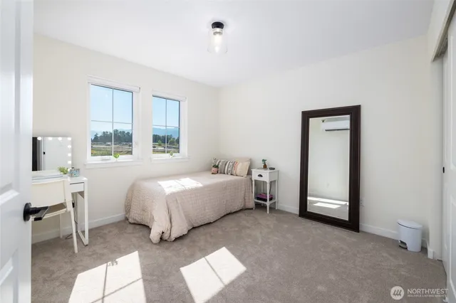 a bathroom with a sink a mirror a vanity and a window