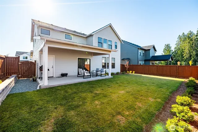 a front view of house with yard and outdoor seating