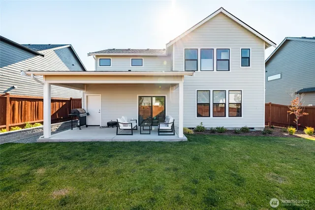 a view of a house with a yard patio and fire pit