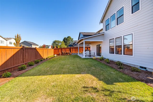 an aerial view of a houses with a swimming pool