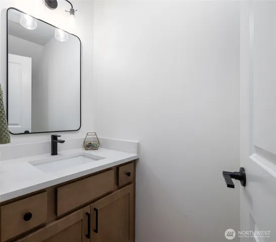 a view of a dining room and livingroom with furniture wooden floor a chandelier