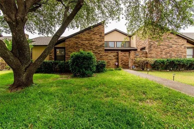 a view of a big yard with large trees