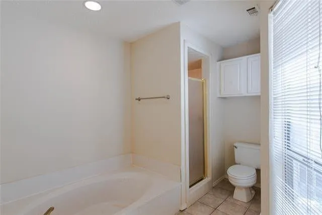 a bathroom with a granite countertop toilet a sink and a bathtub