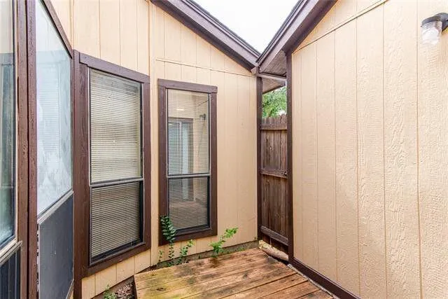 a view of a balcony with wooden floor and entrance