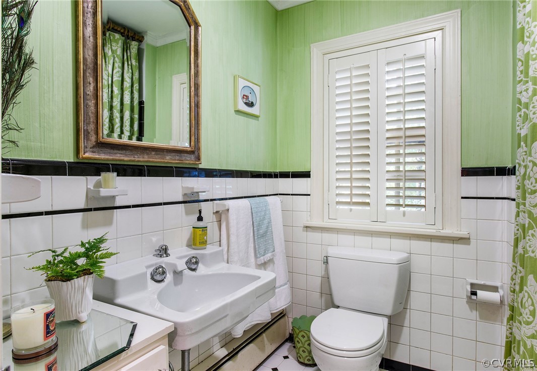 8015 Thom Road Henrico, VA 23229 - Photo 21 of 50 a bathroom with a sink a toilet and mirror