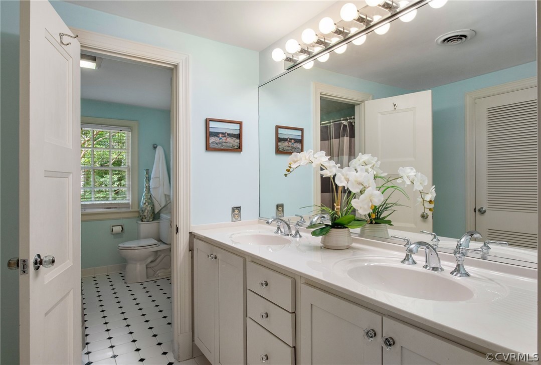 8015 Thom Road Henrico, VA 23229 - Photo 28 of 50 a bathroom with a sink a toilet and a mirror