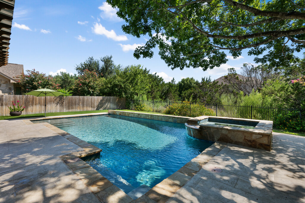 12801 Little Dipper Path Austin, TX 78732 - Photo 1 of 1 View of swimming pool featuring a patio, a fenced backyard, and a pool with connected hot tub