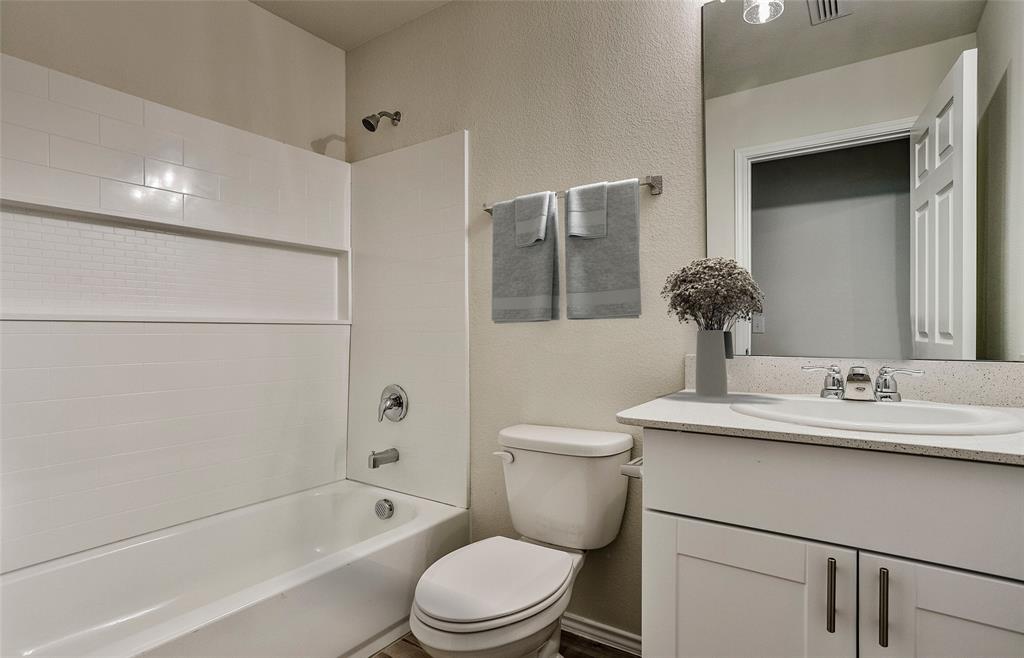 14057 Ladbroke Street Pilot Point, TX 76258 - Photo 3 of 11 a bathroom with a sink a toilet and shower
