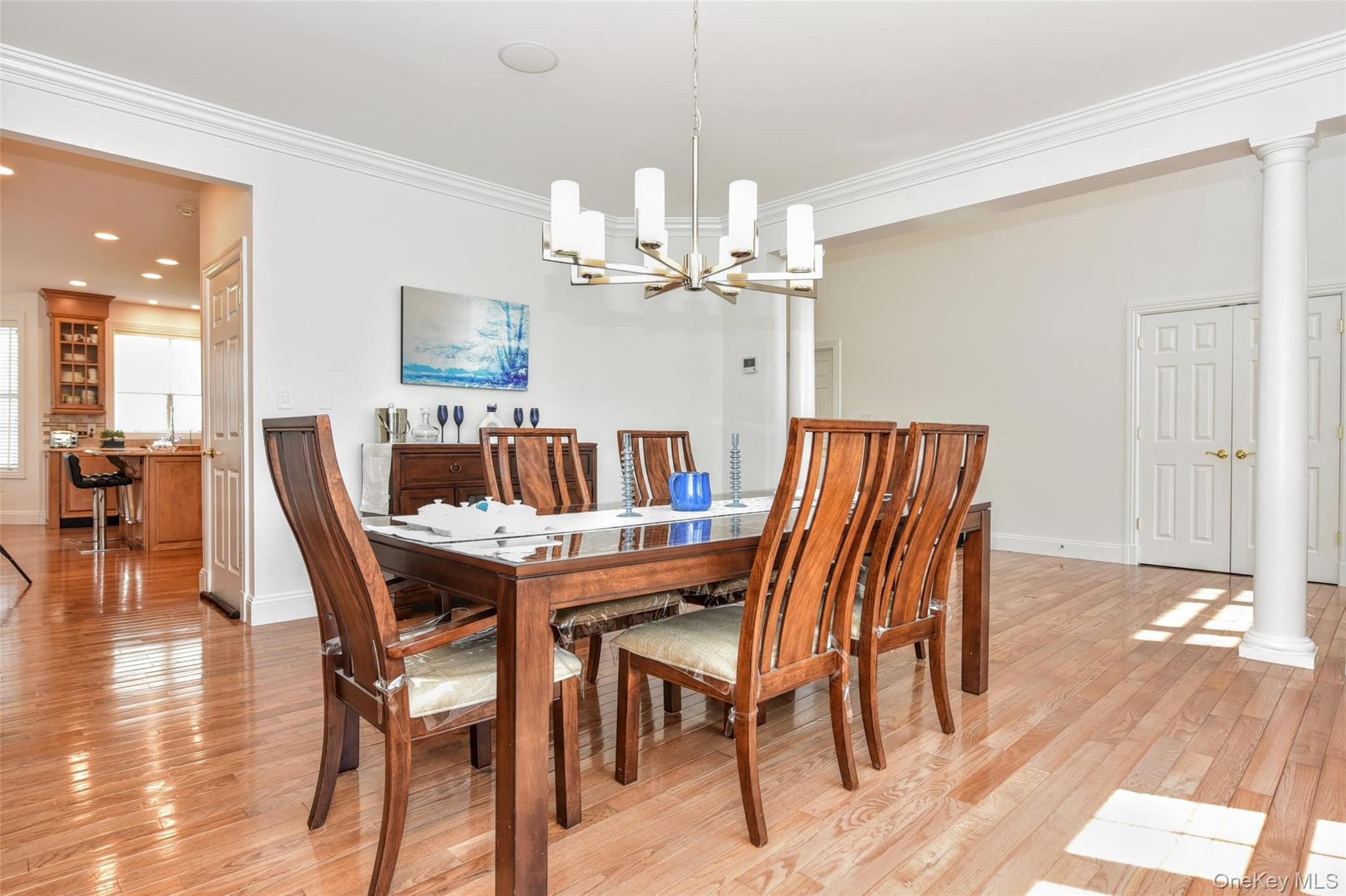 46 Mansion Ridge Boulevard Monroe, NY 10950 - Photo 13 of 46 Bright dining area featuring hardwood flooring, crown molding, and a contemporary chandelier