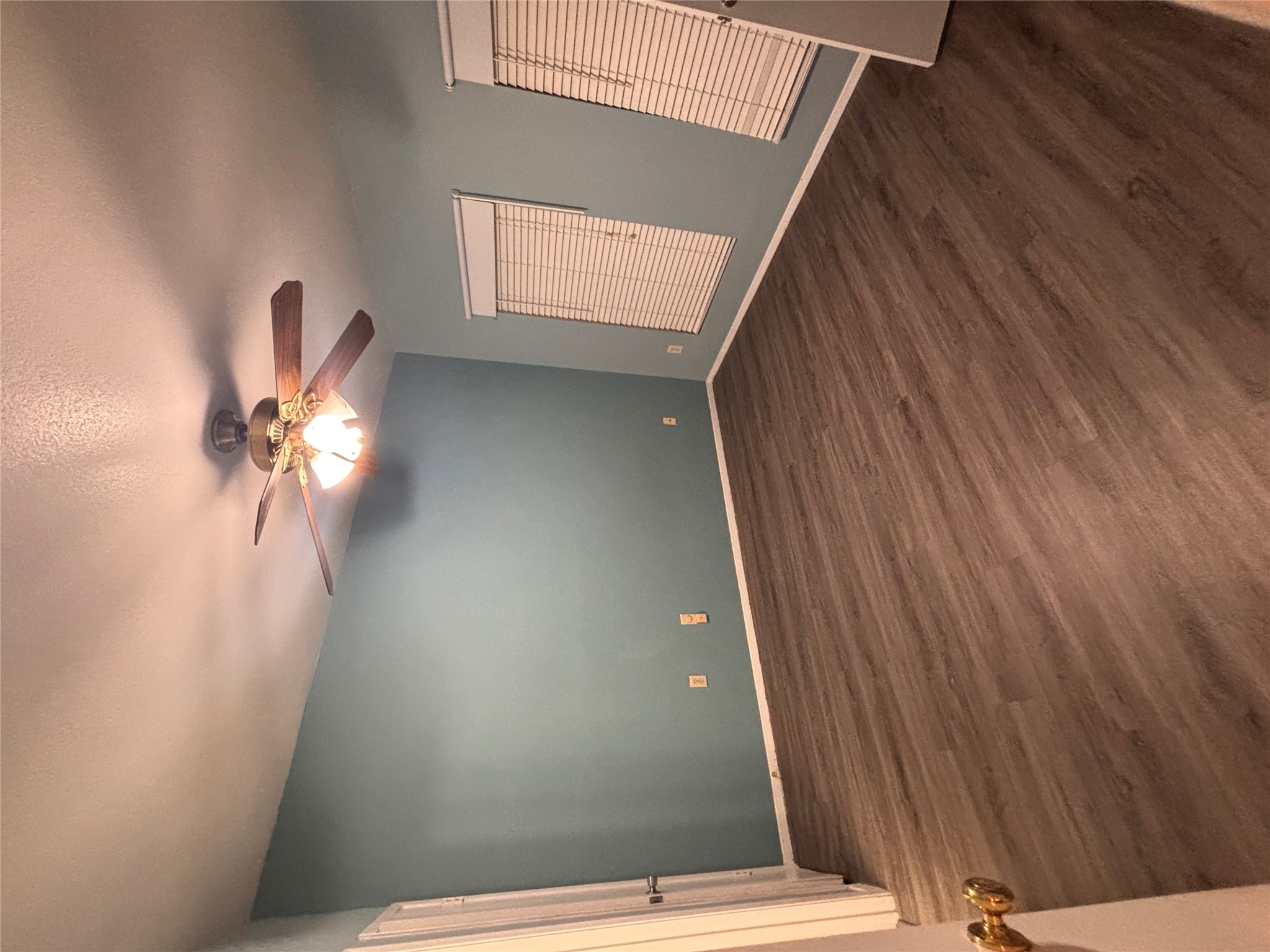 2801 Rio Grande Street, Unit 208 Austin, TX 78705 - Photo 9 of 25 A well-lit bedroom features vaulted ceilings and wood-look flooring.