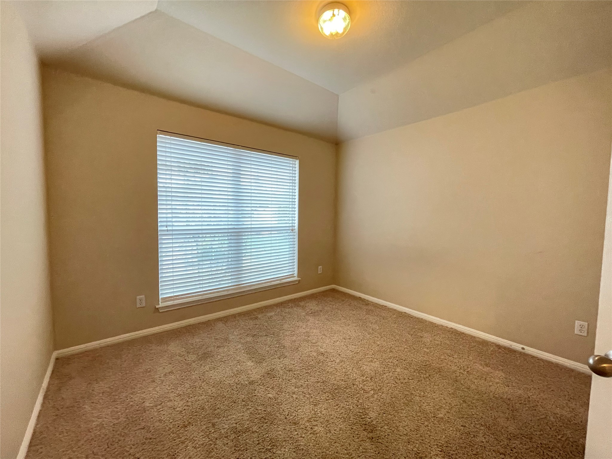11713 Dunblane Way Austin, TX 78754 - Photo 16 of 22 Neutral-toned room featuring a single window with horizontal blinds, a tray ceiling, and a flush-mount light fixture