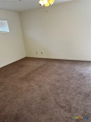 a view of a big room with closet and windows