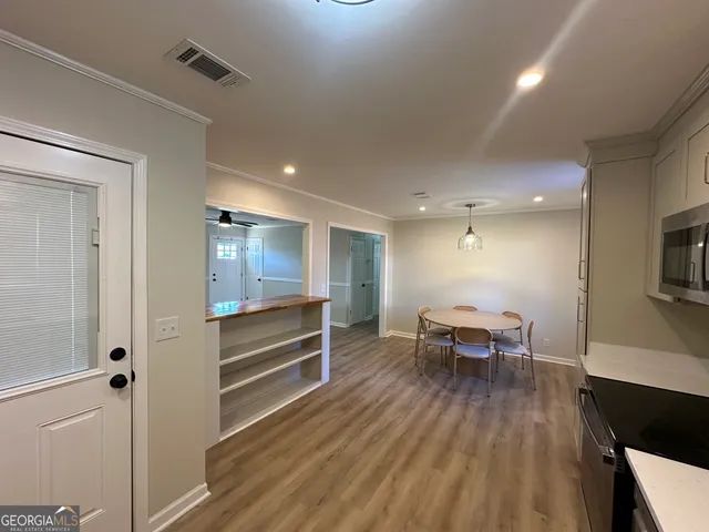 a view of dining room with furniture and wooden floor