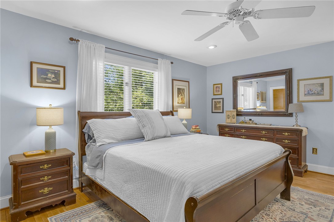 218 Northridge Drive Anderson, SC 29621 - Photo 21 of 50 Hardwood floors and a ceiling fan enhance this peaceful sleeping area, illuminated by a window overlooking greenery.
