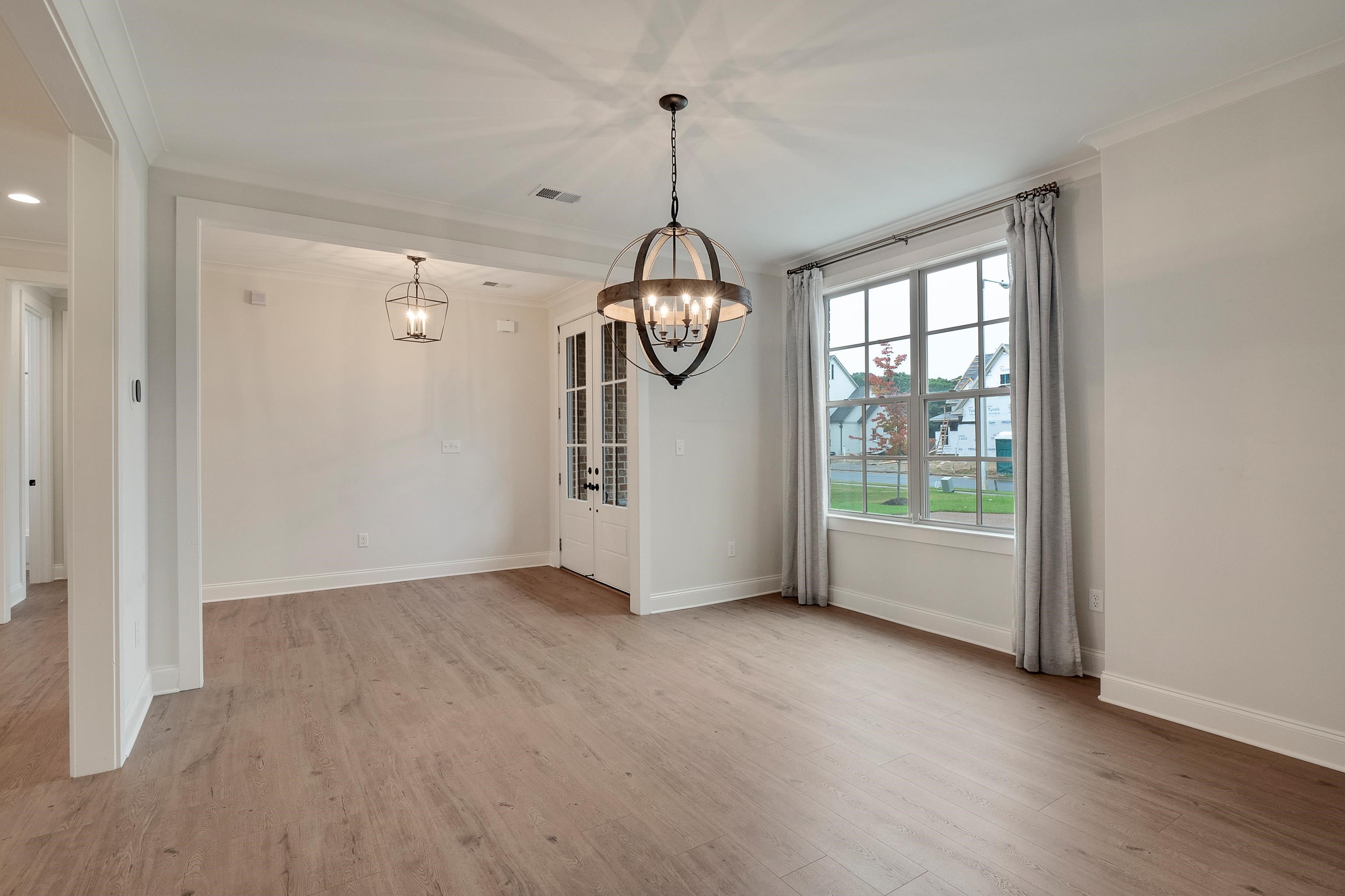 1365 Belfair Drive Collierville, TN 38017 - Photo 18 of 39 a view of an empty room with window and wooden floor