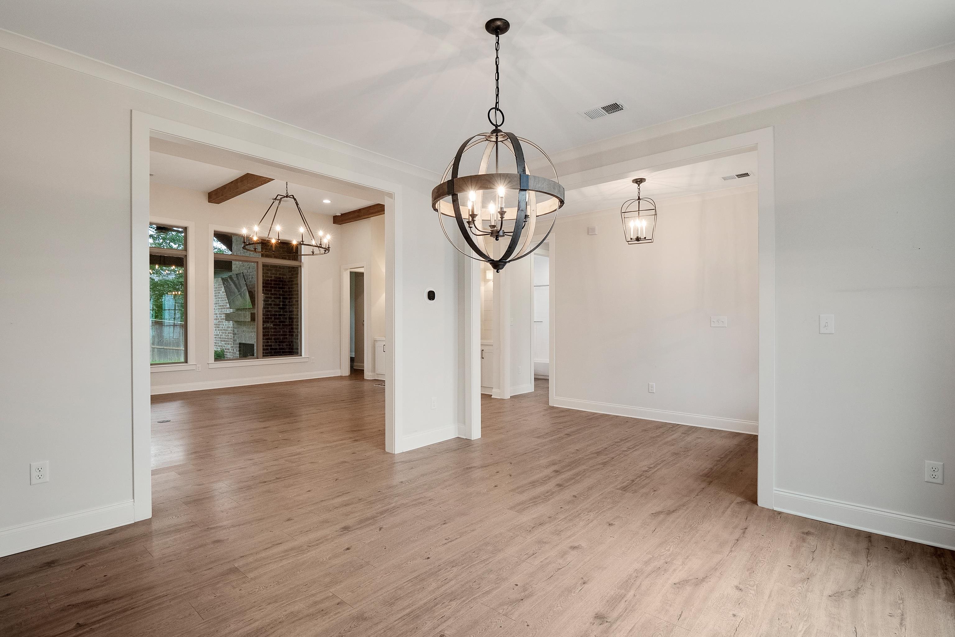 1365 Belfair Drive Collierville, TN 38017 - Photo 19 of 39 a view of a hallway with wooden floor and a chandelier