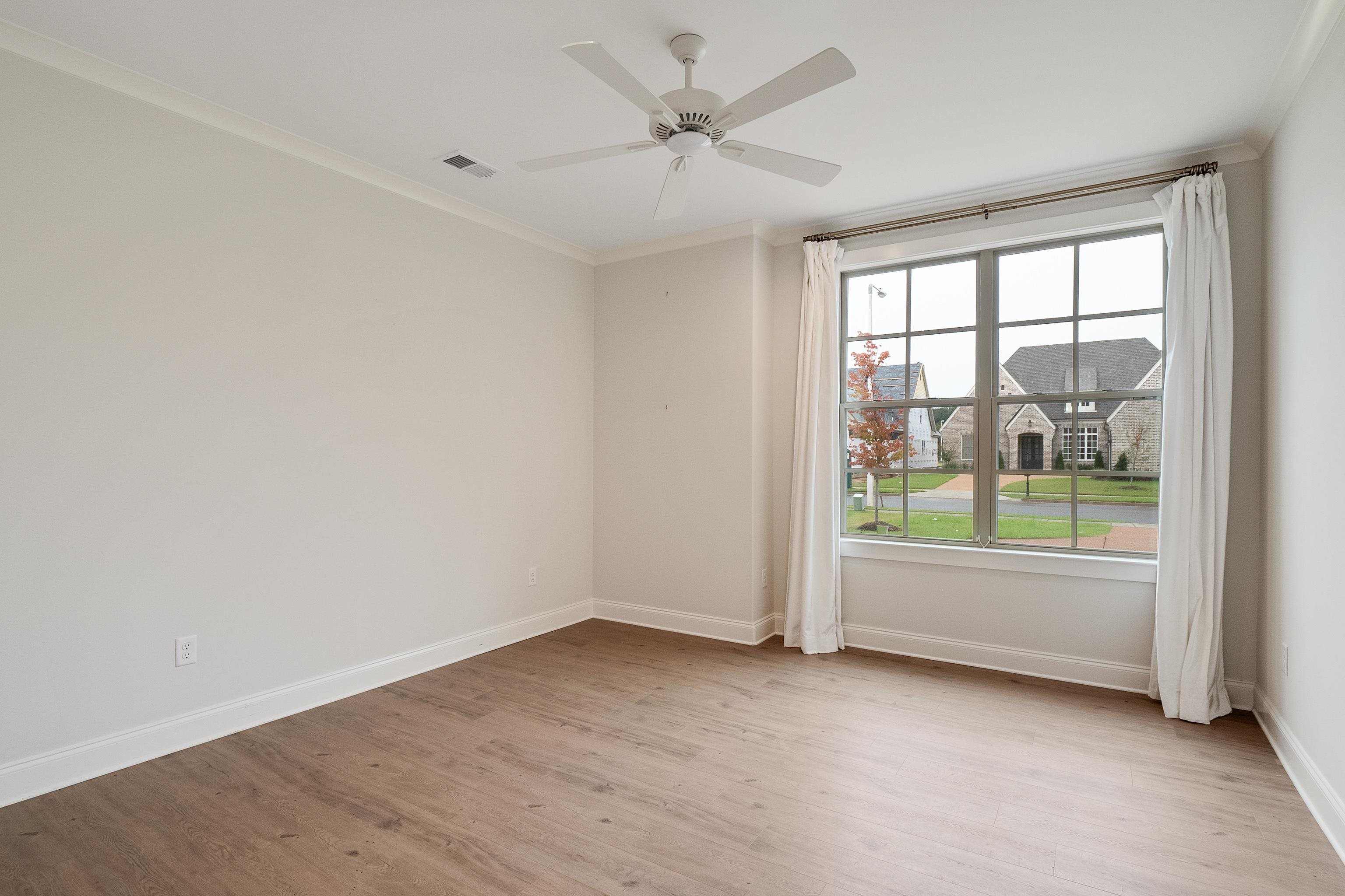 1365 Belfair Drive Collierville, TN 38017 - Photo 20 of 39 an empty room with a window and a ceiling fan