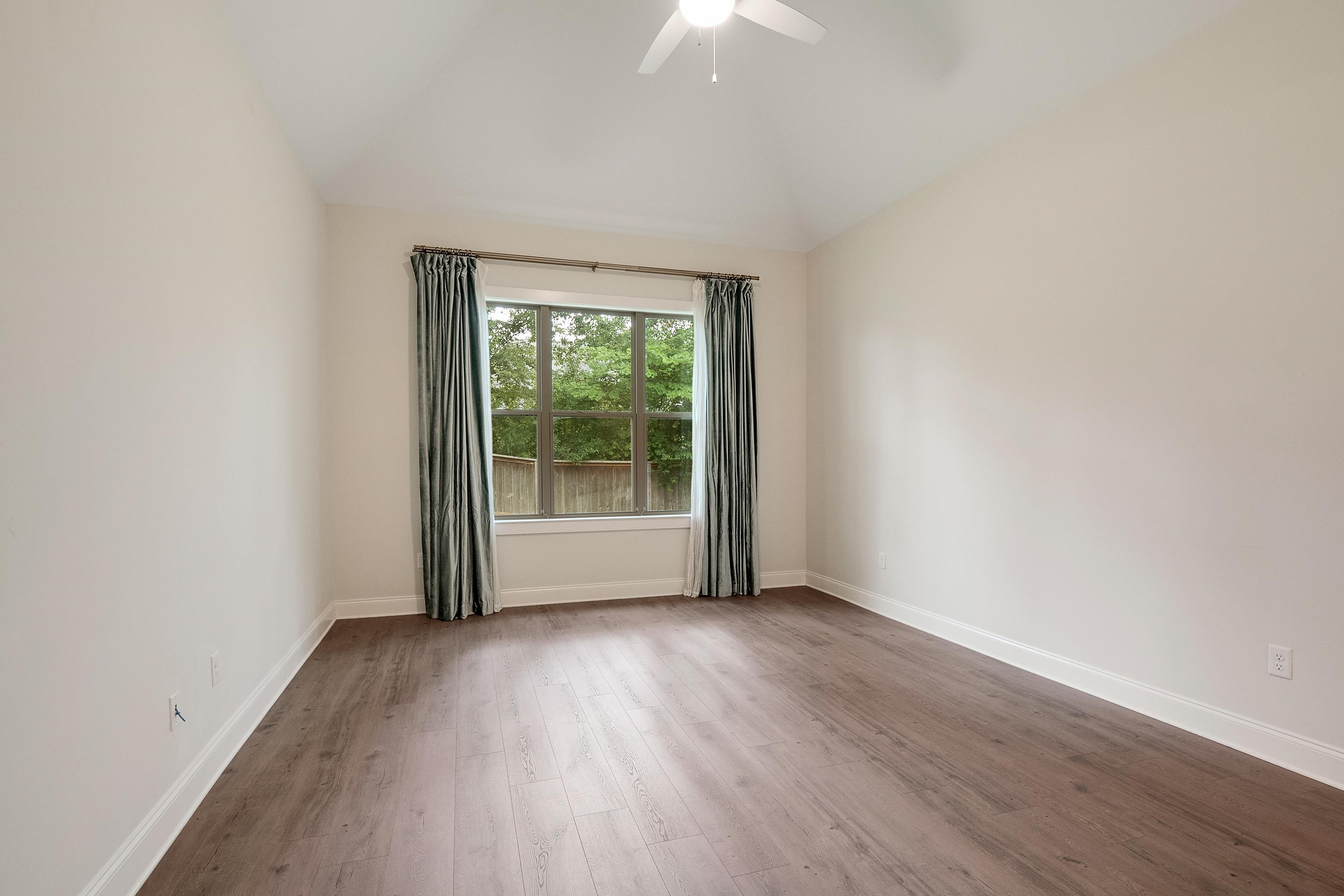 1365 Belfair Drive Collierville, TN 38017 - Photo 23 of 39 an empty room with wooden floor and windows