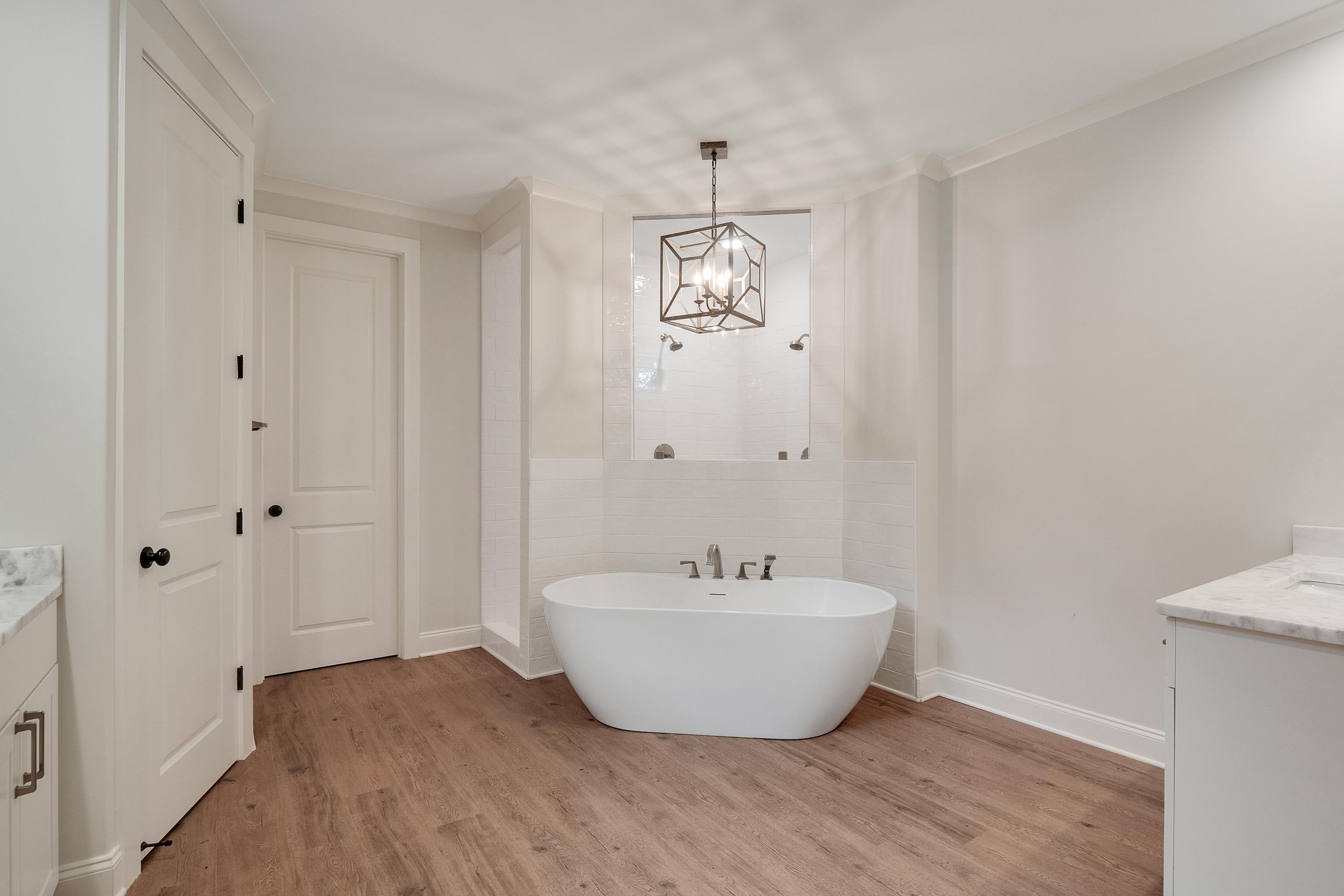 1365 Belfair Drive Collierville, TN 38017 - Photo 25 of 39 a view of a bathroom with sink mirror and bathtub