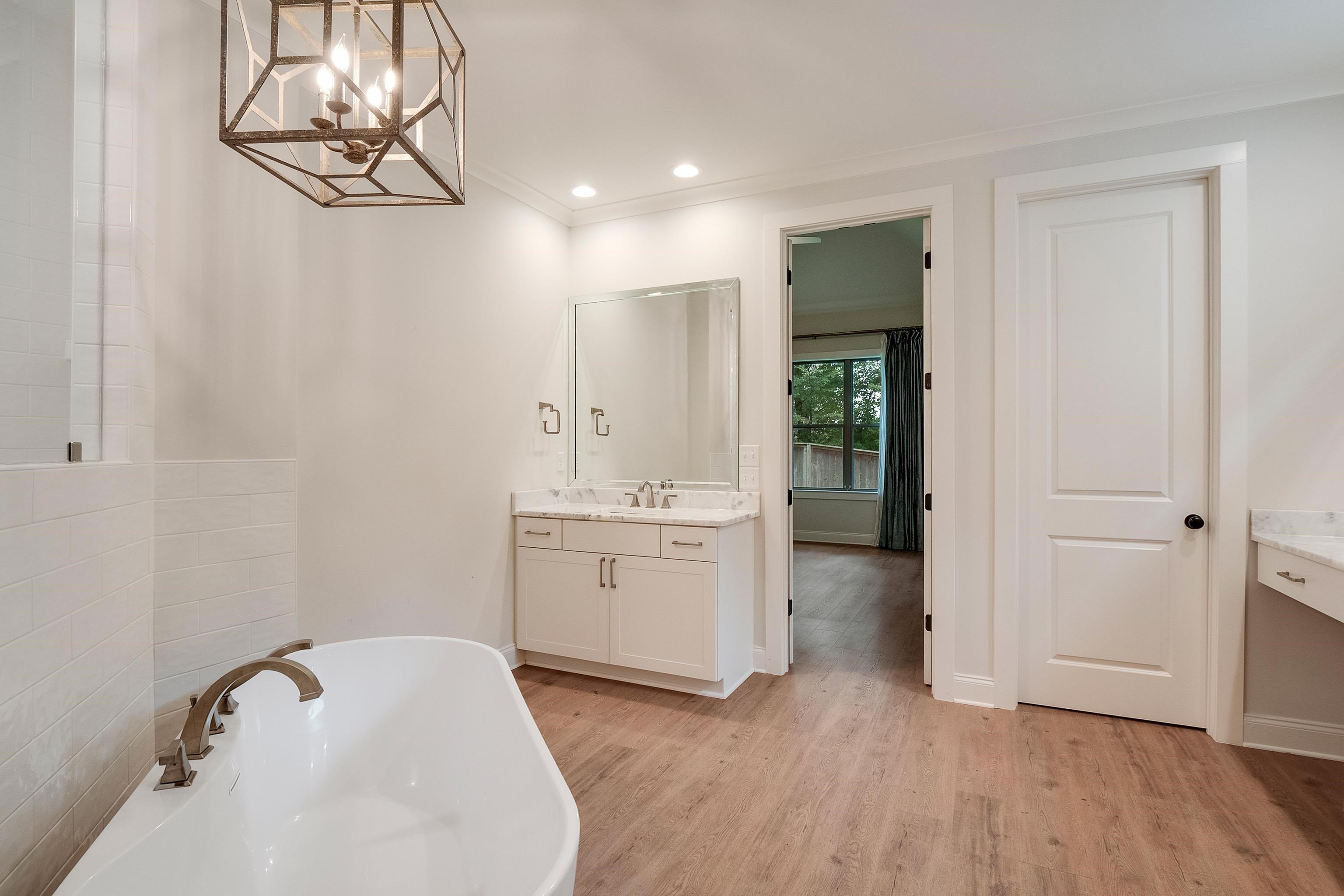 1365 Belfair Drive Collierville, TN 38017 - Photo 26 of 39 a bathroom with a tub sink and mirror