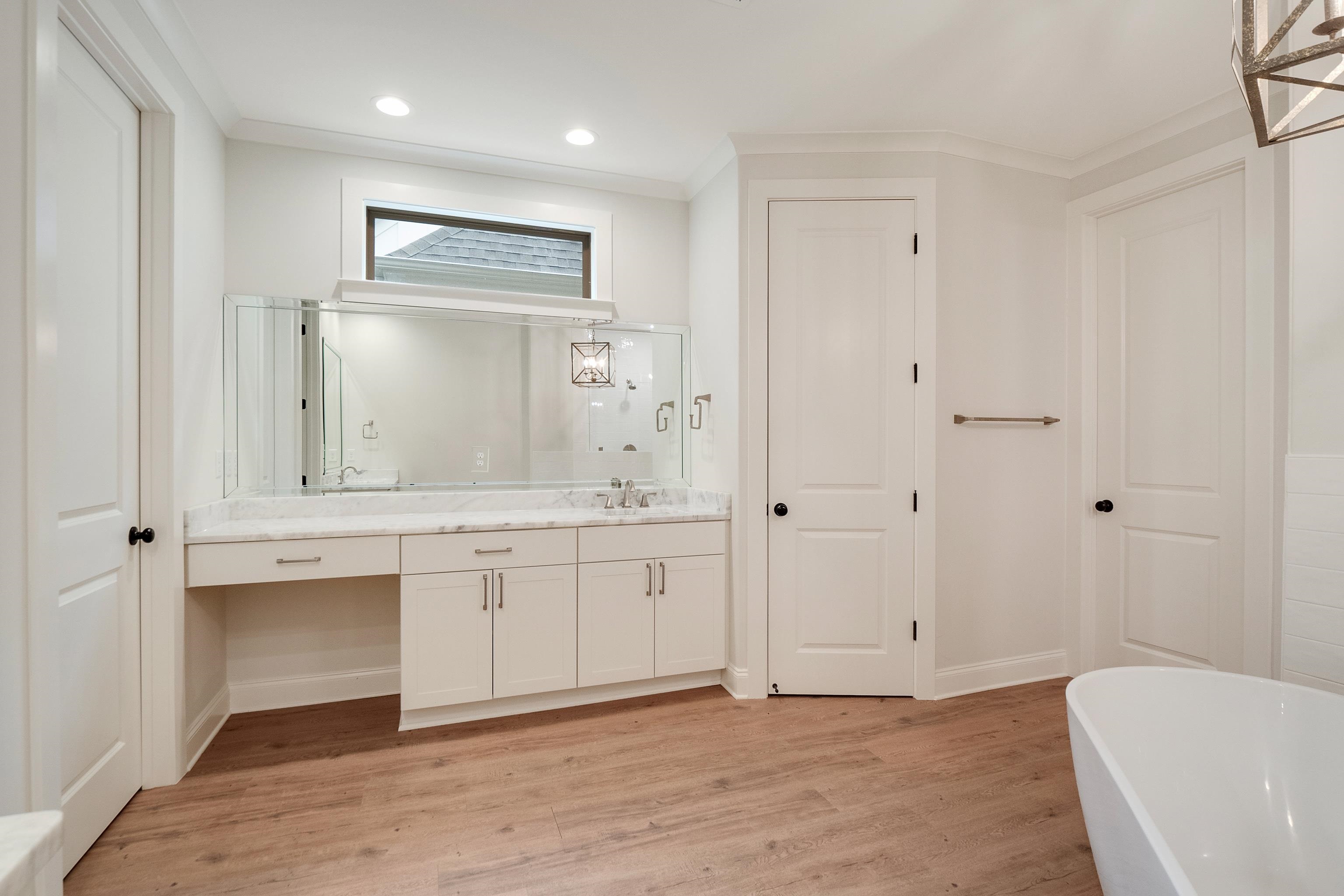 1365 Belfair Drive Collierville, TN 38017 - Photo 28 of 39 a spacious bathroom with a granite countertop sink and a mirror