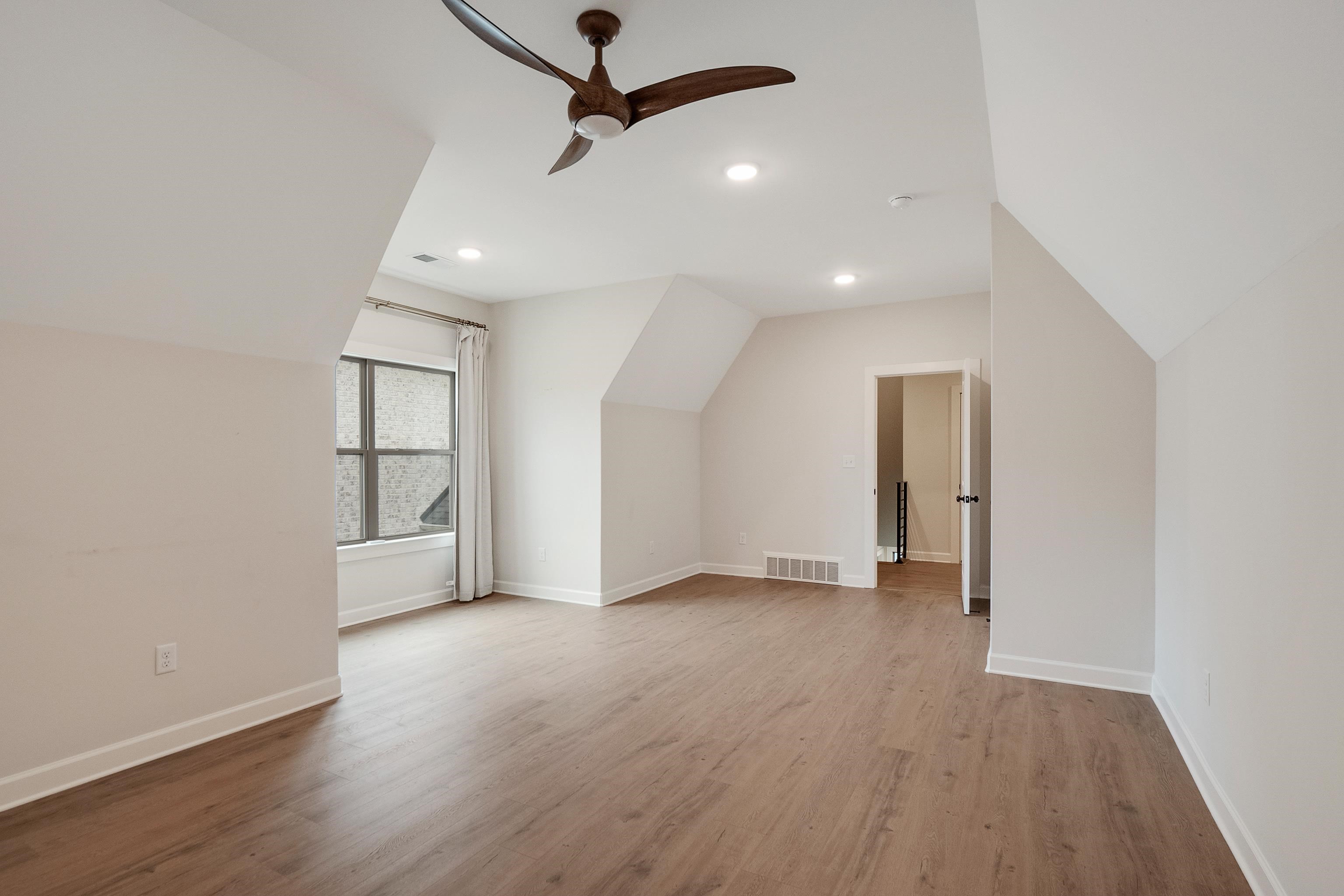 1365 Belfair Drive Collierville, TN 38017 - Photo 30 of 39 an empty room with wooden floor and windows