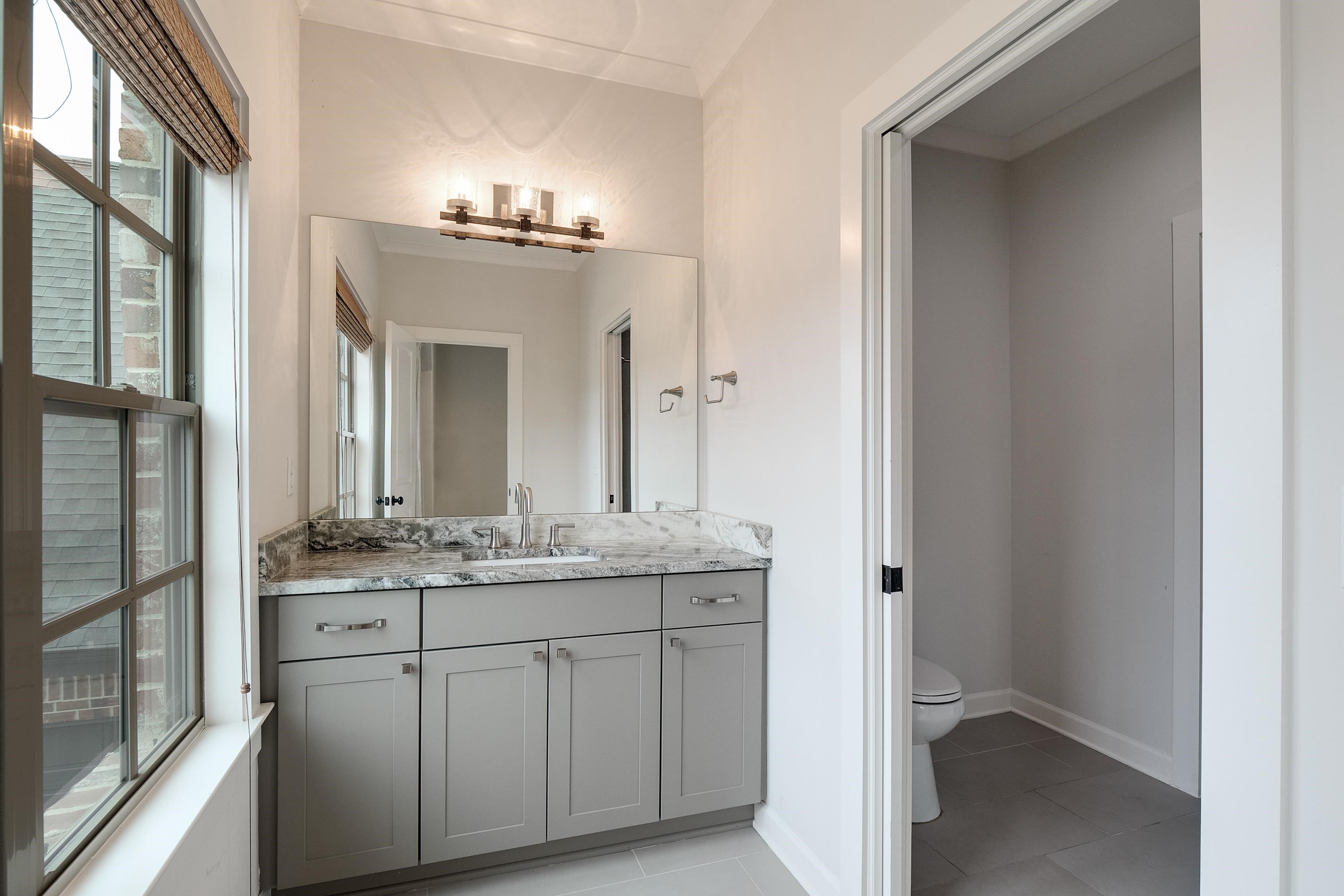 1365 Belfair Drive Collierville, TN 38017 - Photo 37 of 39 a bathroom with a double vanity sink and a mirror