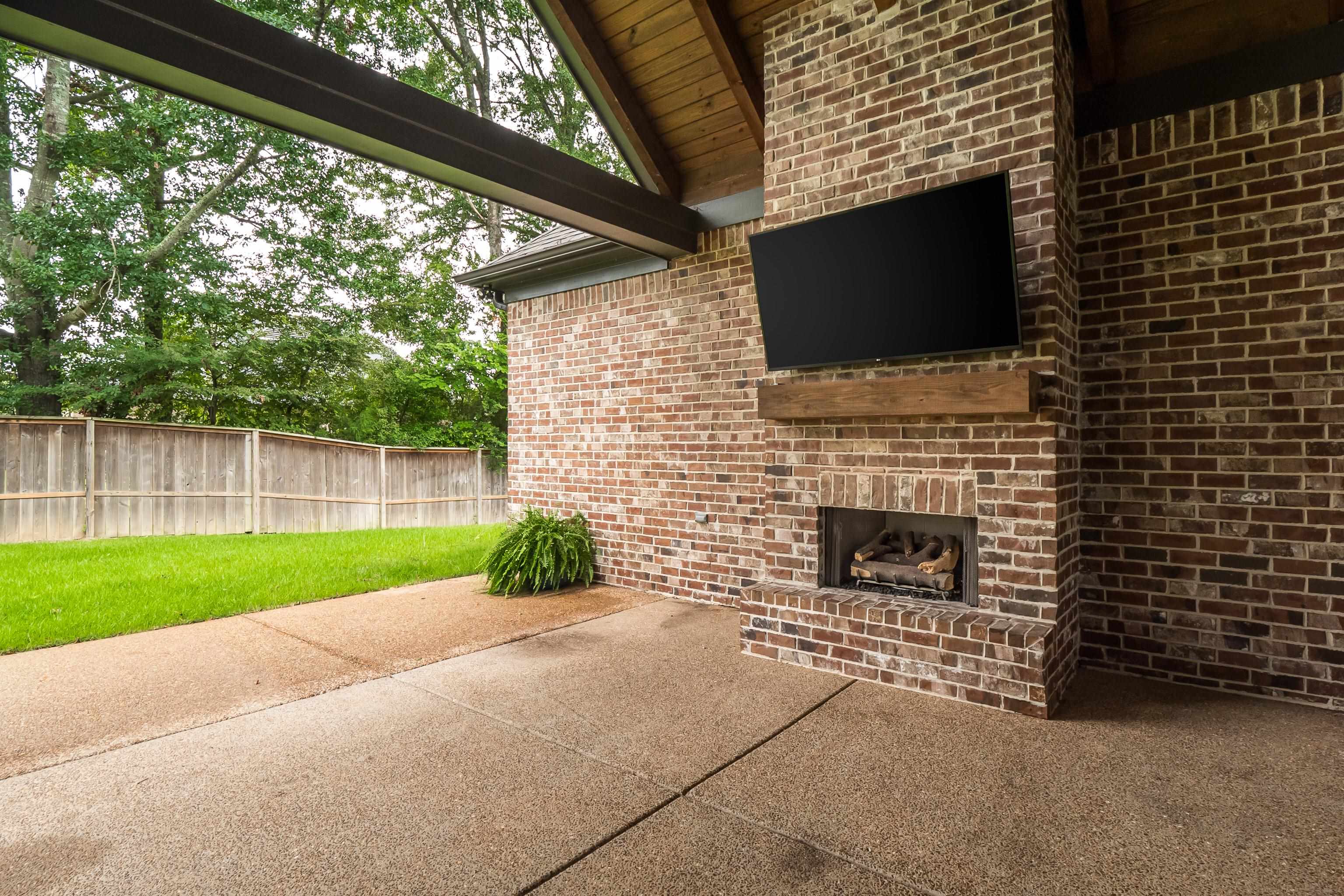 1365 Belfair Drive Collierville, TN 38017 - Photo 38 of 39 a backyard of a house with oven and outdoor seating
