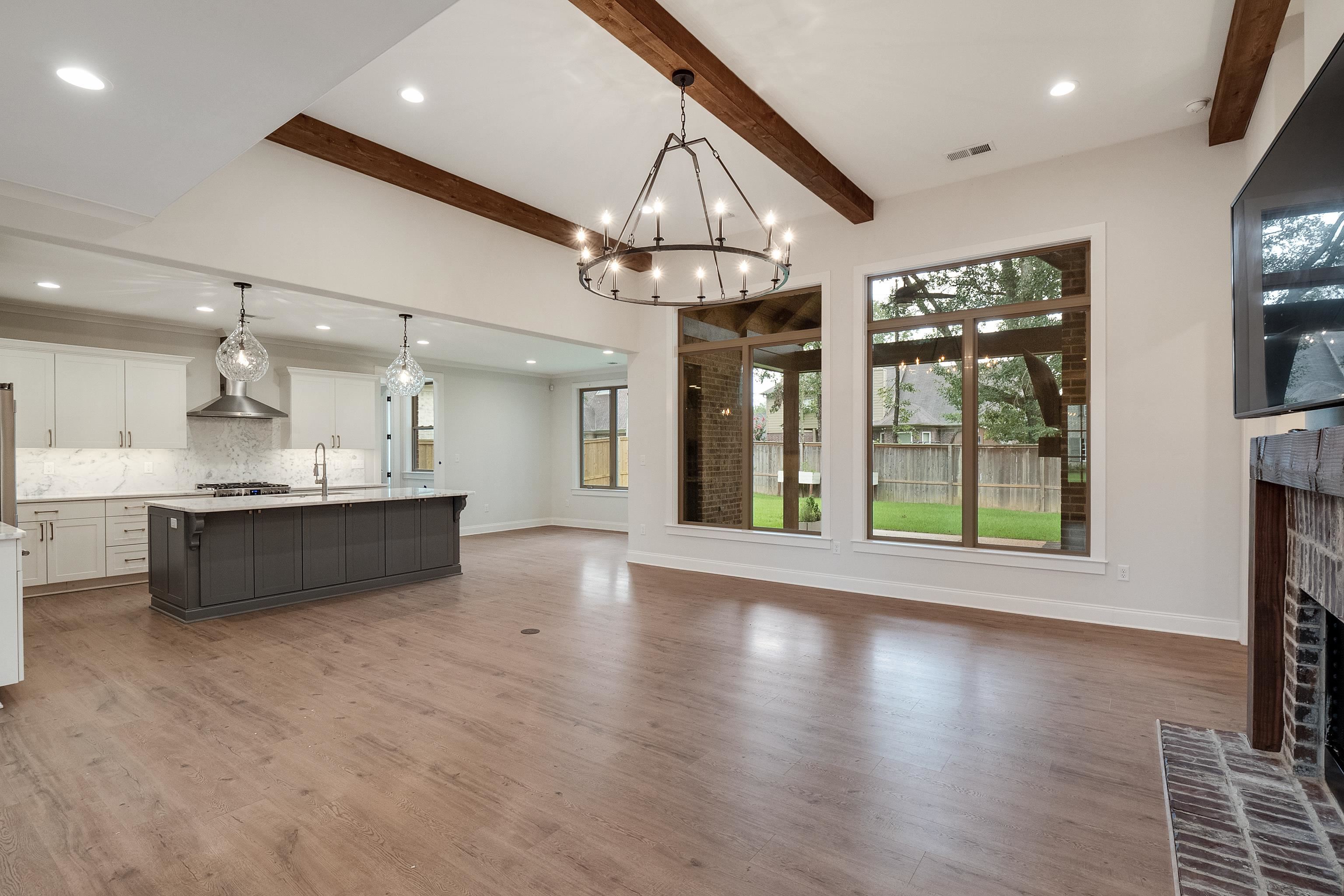 1365 Belfair Drive Collierville, TN 38017 - Photo 4 of 39 a large kitchen with granite countertop a large counter top stainless steel appliances and wooden floor