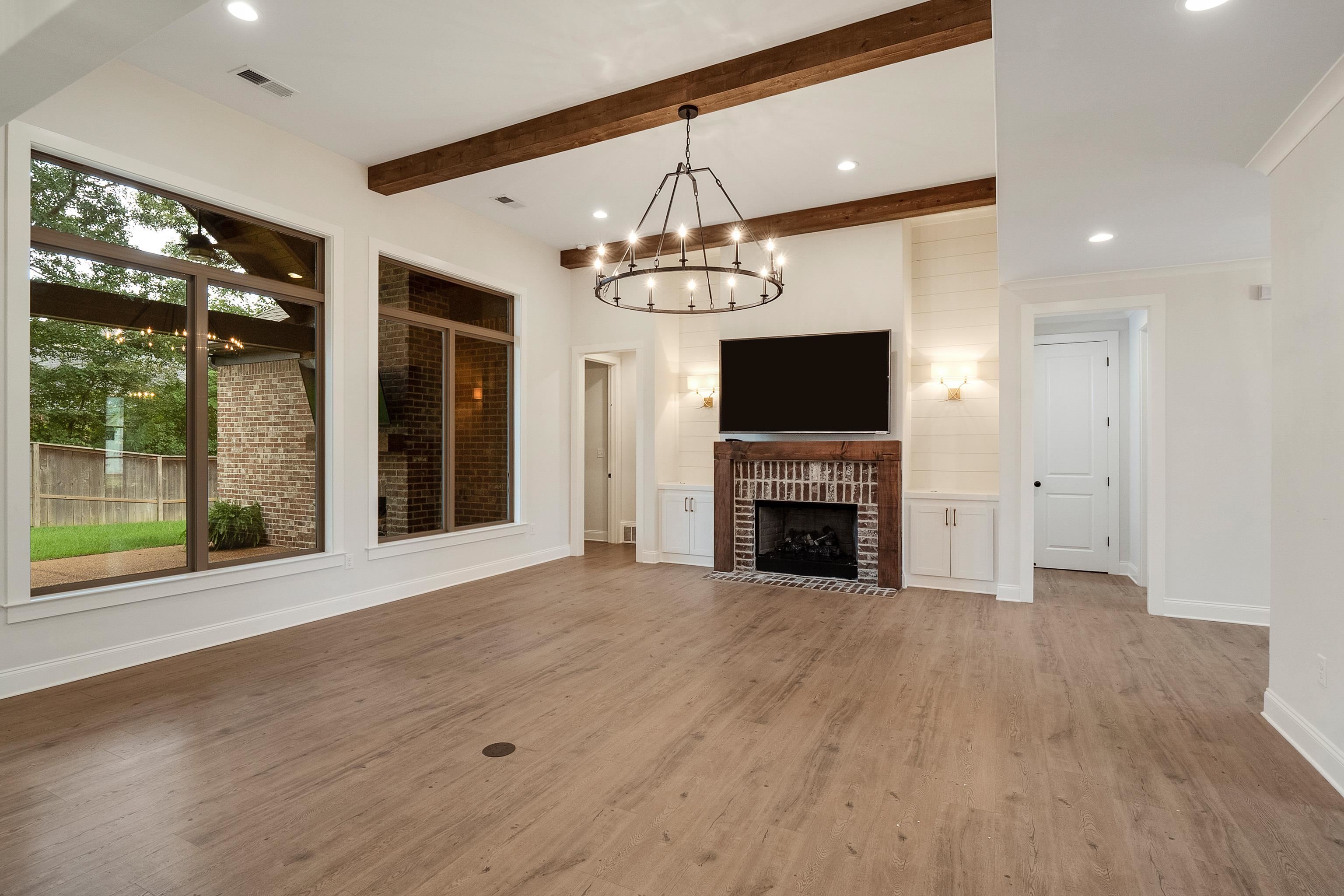 1365 Belfair Drive Collierville, TN 38017 - Photo 5 of 39 a view of a livingroom with a fireplace and chandelier
