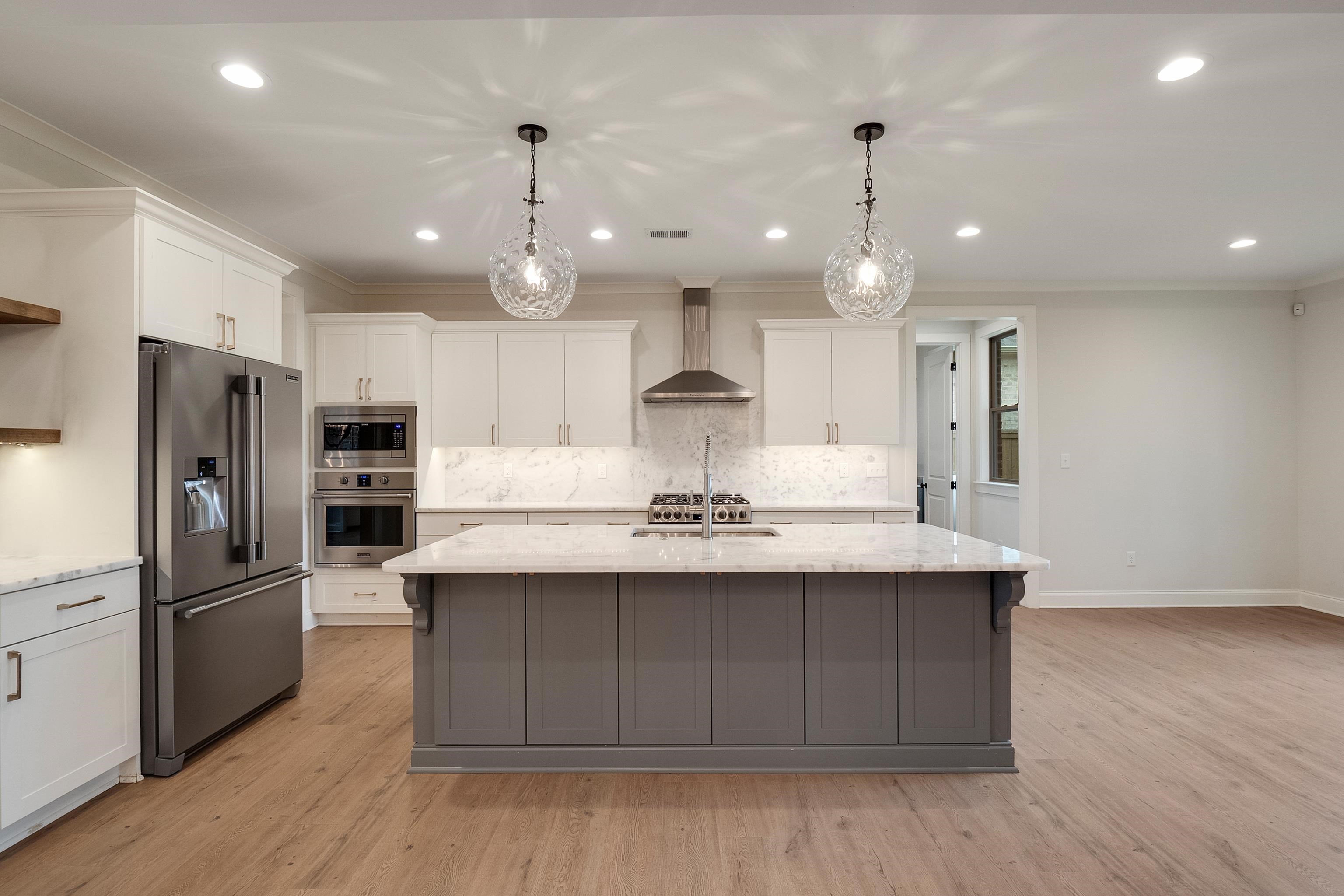 1365 Belfair Drive Collierville, TN 38017 - Photo 8 of 39 a kitchen with kitchen island a sink stainless steel appliances and wooden floor