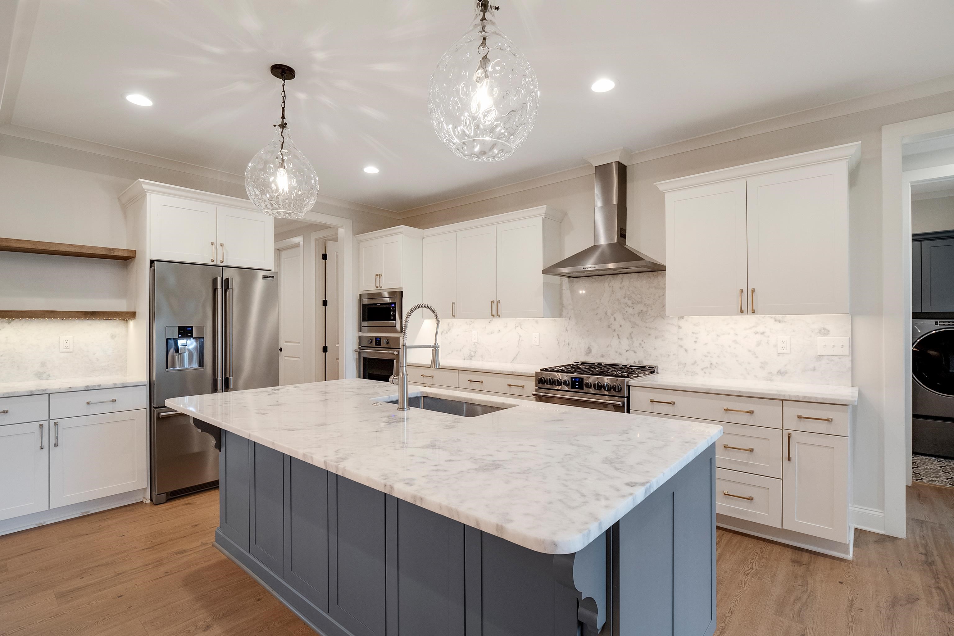 1365 Belfair Drive Collierville, TN 38017 - Photo 9 of 39 a kitchen with stainless steel appliances granite countertop a sink refrigerator and cabinets