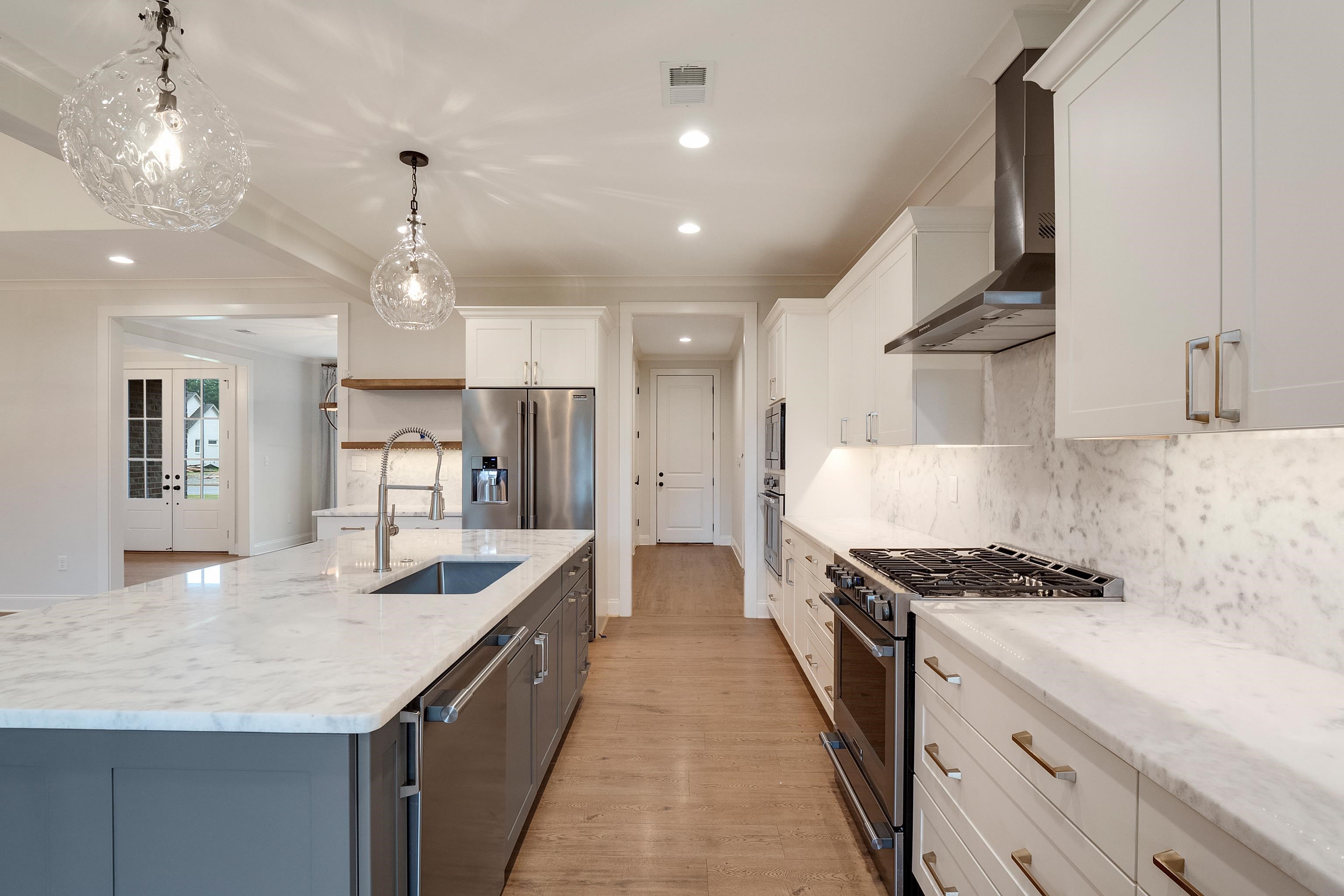 1365 Belfair Drive Collierville, TN 38017 - Photo 10 of 39 a kitchen with kitchen island a counter top space a sink stainless steel appliances and cabinets