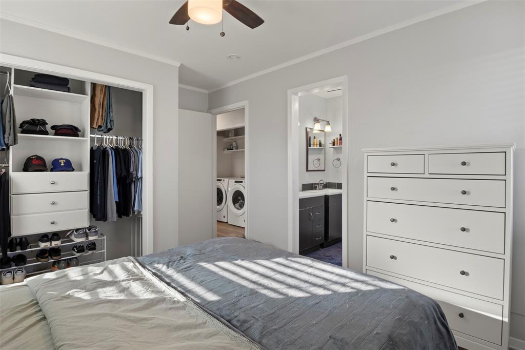 3518 Windsor Street Irving, TX 75062 - Photo 14 of 21 a bedroom with a bed and a chandelier