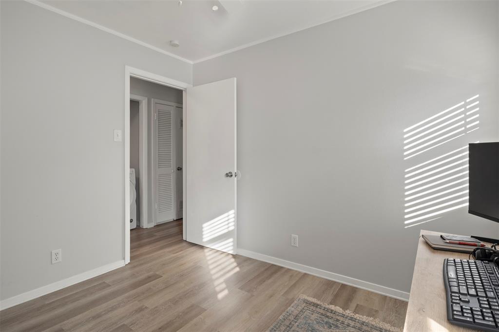 3518 Windsor Street Irving, TX 75062 - Photo 16 of 21 a view of an empty room with wooden floor and a window