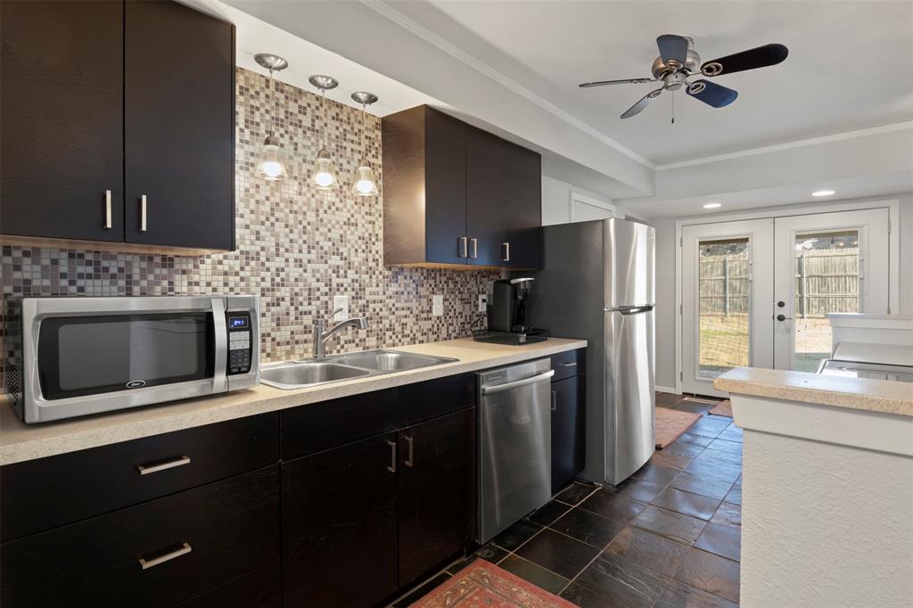 3518 Windsor Street Irving, TX 75062 - Photo 4 of 21 a kitchen with stainless steel appliances kitchen island granite countertop a refrigerator a sink and dishwasher
