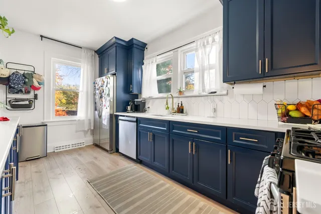 a kitchen with stainless steel appliances granite countertop a refrigerator and a stove top oven