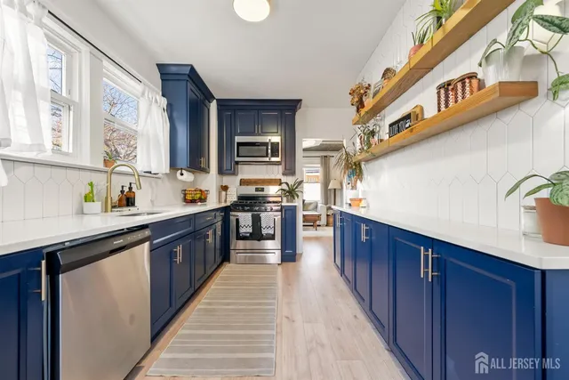 a large kitchen with stainless steel appliances kitchen island a large counter space a sink and a stove