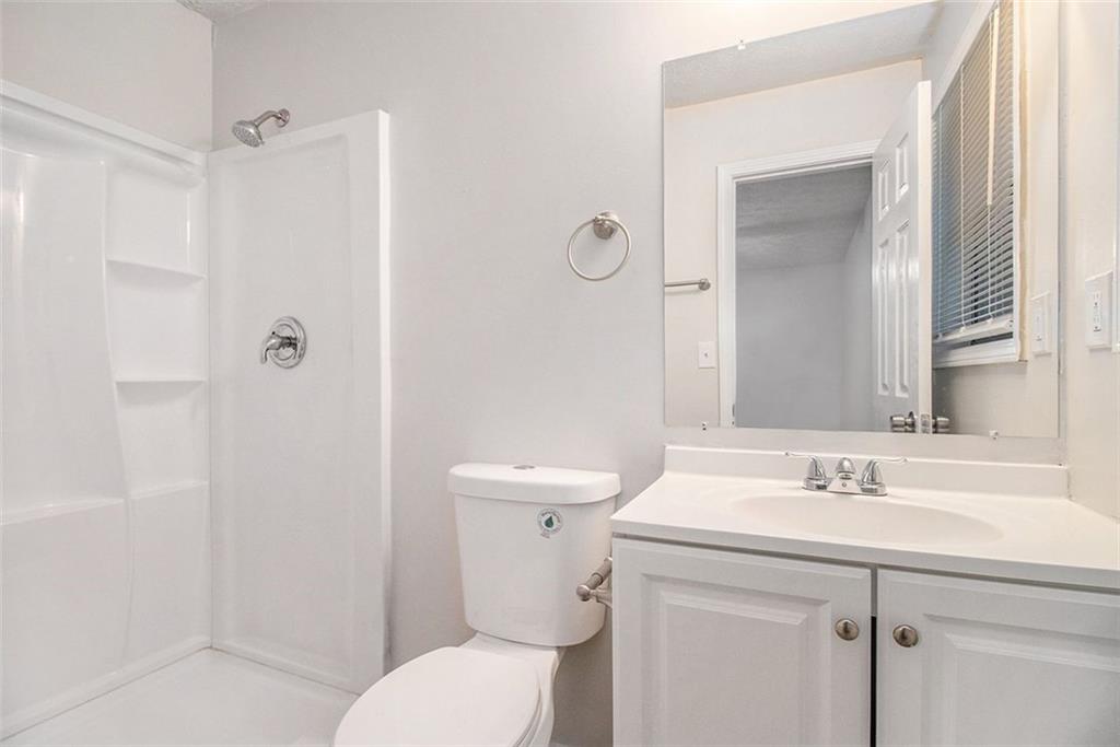 1748 Charmeth Road Lithonia, GA 30058 - Photo 12 of 32 a bathroom with a sink toilet and shower