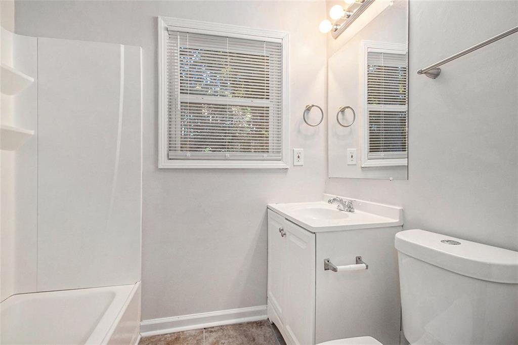 1748 Charmeth Road Lithonia, GA 30058 - Photo 13 of 32 a bathroom with a sink and a toilet