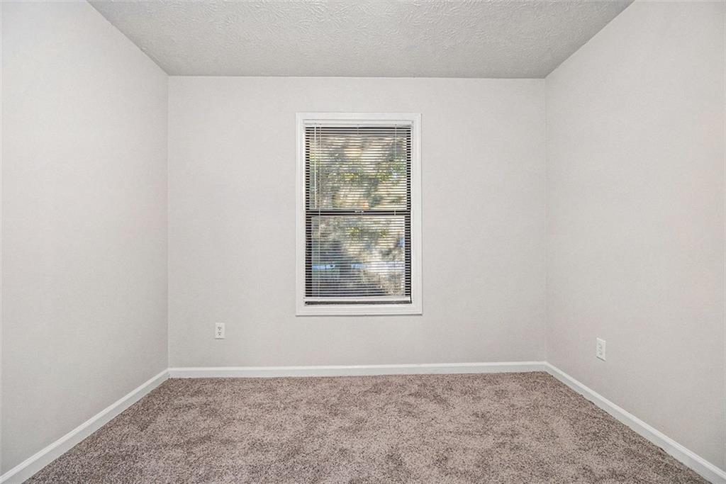 1748 Charmeth Road Lithonia, GA 30058 - Photo 14 of 32 an empty room with window