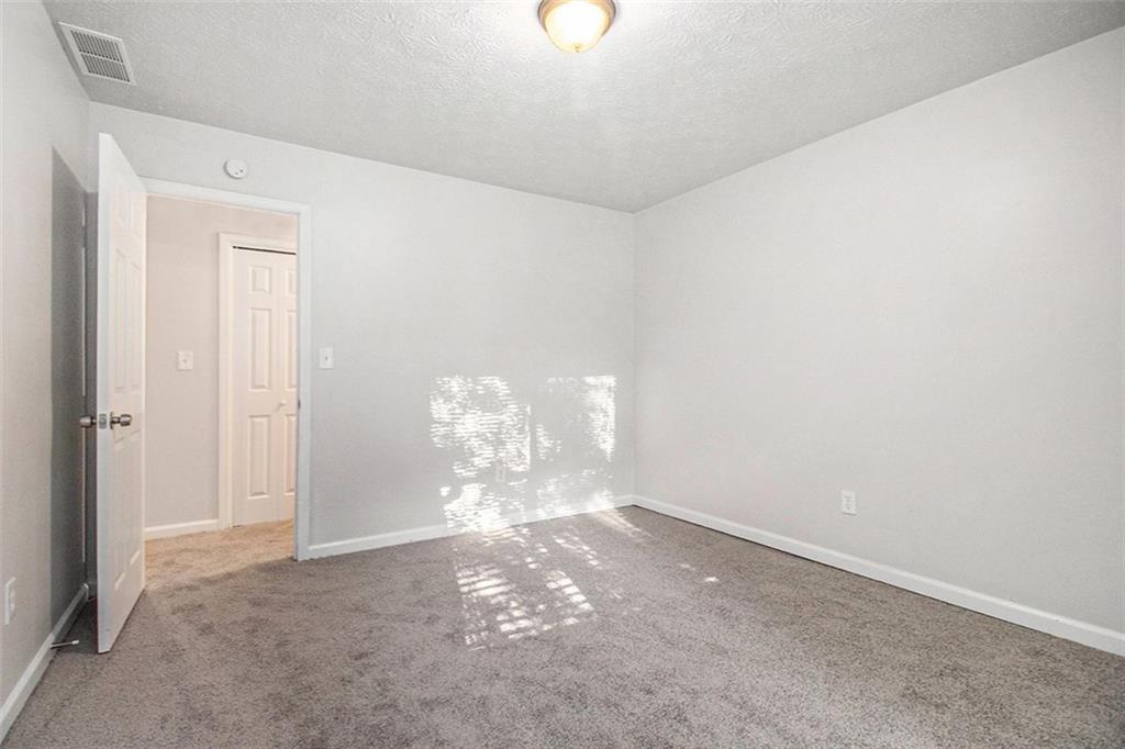 1748 Charmeth Road Lithonia, GA 30058 - Photo 16 of 32 a view of a chandelier fan and kitchen in the background
