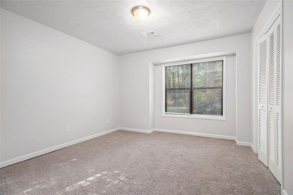 1748 Charmeth Road Lithonia, GA 30058 - Photo 18 of 32 an empty room with windows