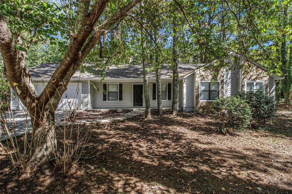 1748 Charmeth Road Lithonia, GA 30058 - Photo 24 of 32 a view of house with a tree in front of it