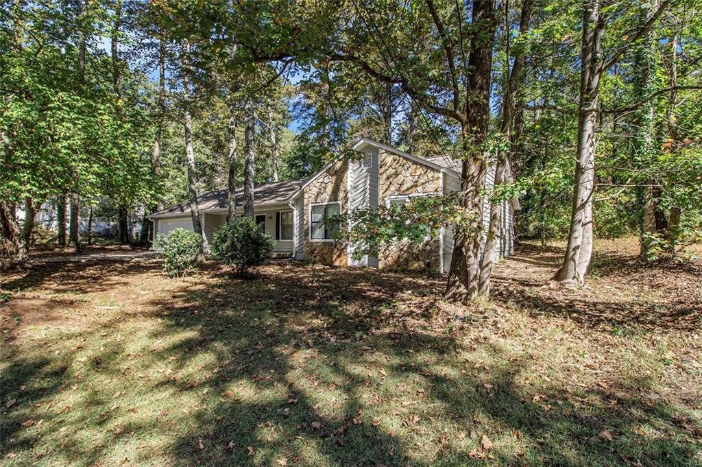 1748 Charmeth Road Lithonia, GA 30058 - Photo 26 of 32 a view of a house with a tree