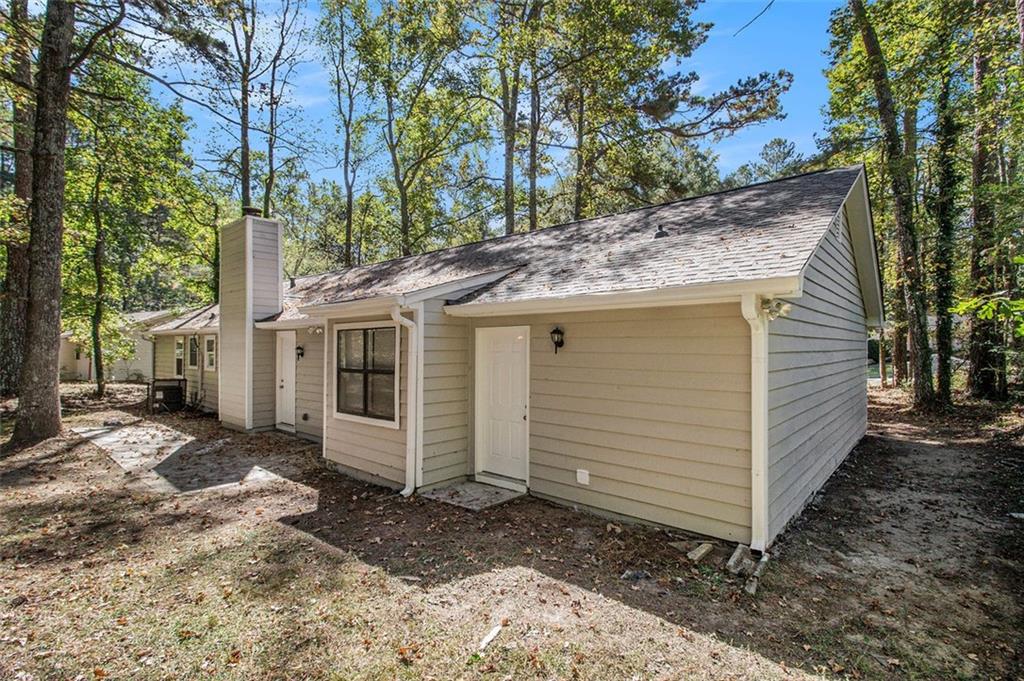 1748 Charmeth Road Lithonia, GA 30058 - Photo 29 of 32 a view of a house with a yard